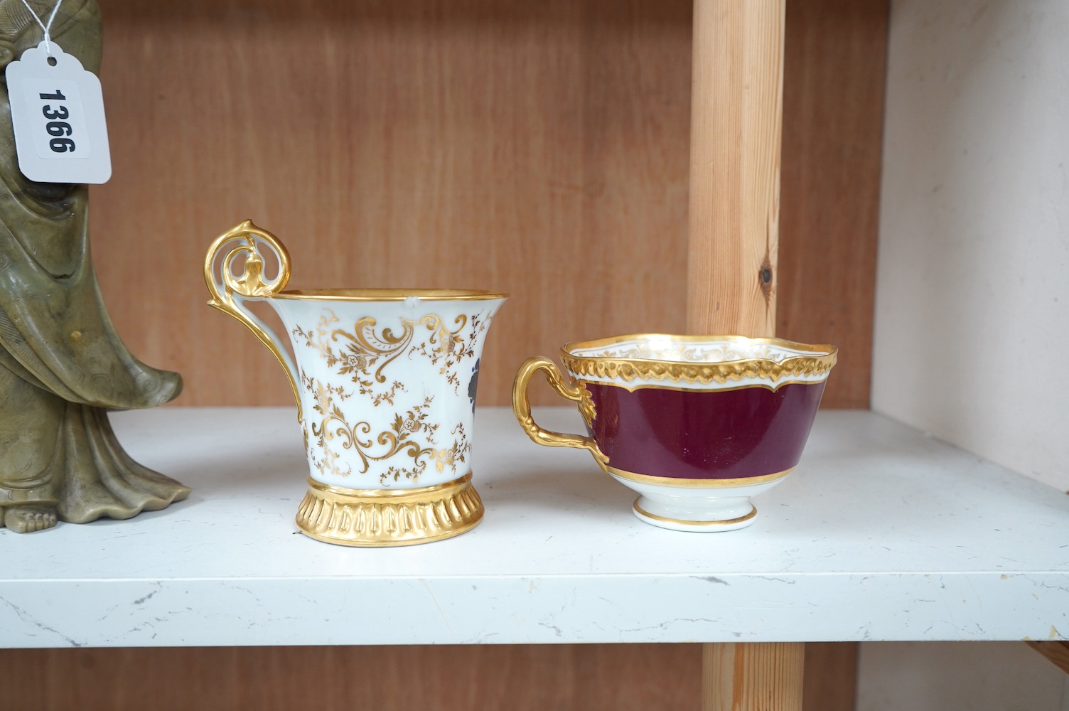 An armorial mug with lithophane figural scene to the base, together with a similar cup, largest 12cm high. Condition - mug poor, cup is good